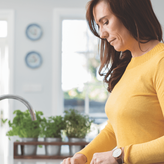 Author doing meal prep in bright kitchen