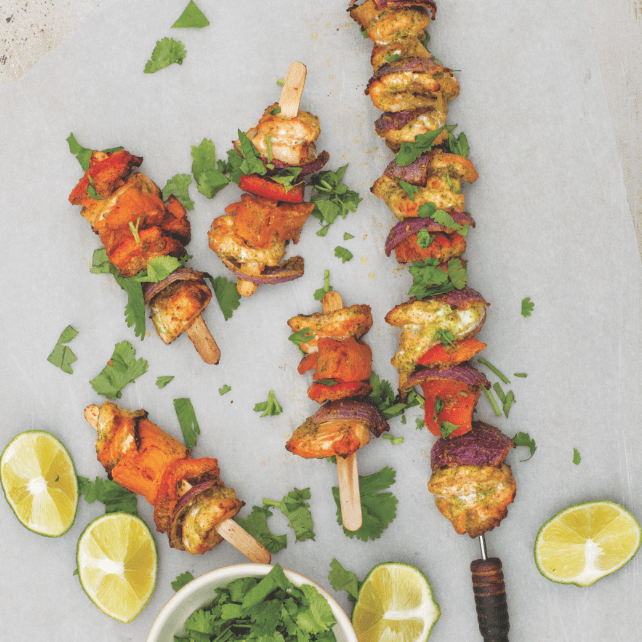 Salmon and veggie skewers recipe from baby friendly family cookbook on grey background