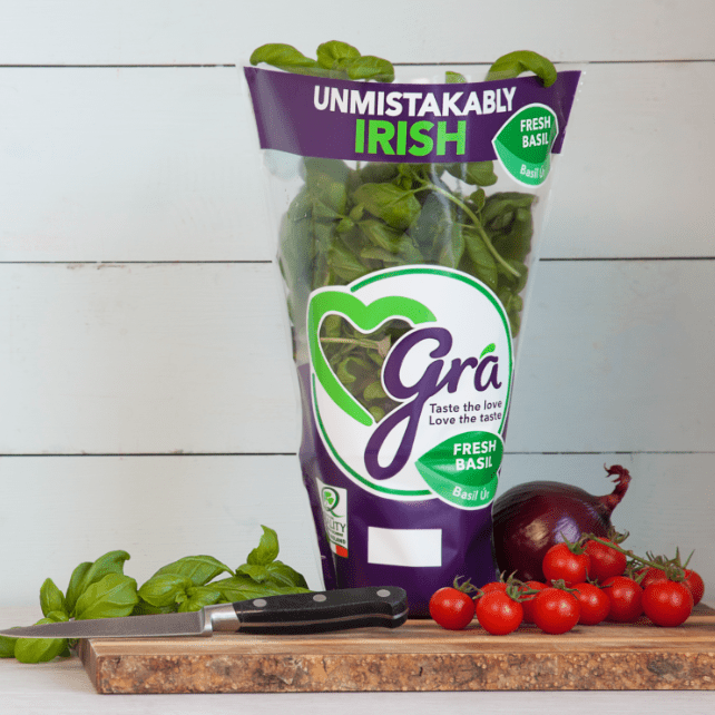 Gra basil pot standing on chopping board with other fresh ingredients