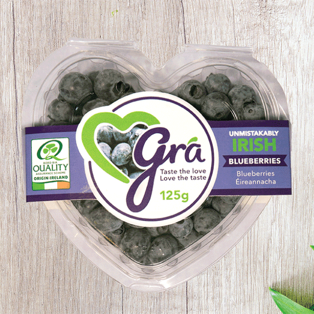 overhead view of Gra blueberry packaging on wooden background