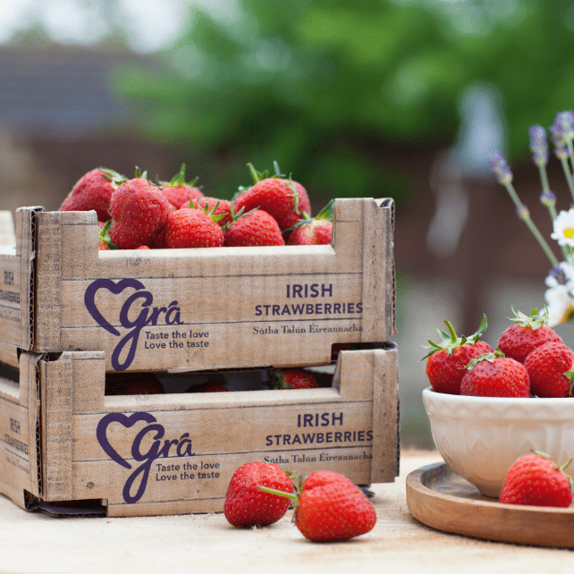 Gra strawberry boxes displayed on outdoor table