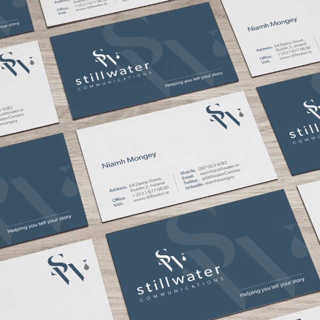 Stillwater business cards displayed flat on wooden background