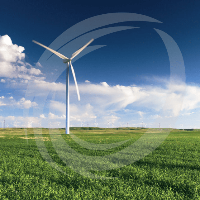 Wind turbine in green field with blue skies and wellman International logo watermarked over it