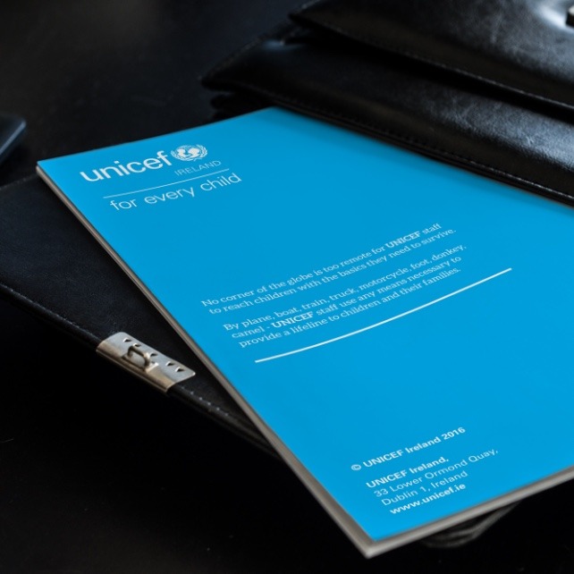 Unicef back cover design coming out of black briefcase