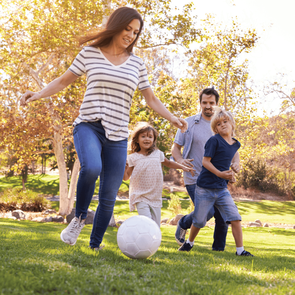 Photo of family playing football